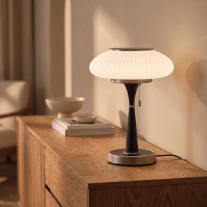 Brontea lamp lit on an oak sideboard
