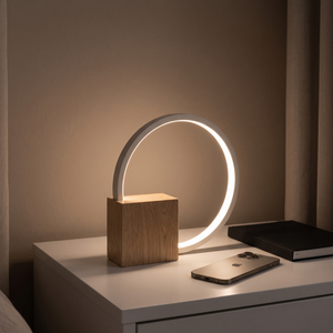 Lunara lamp glowing on a nightstand at night